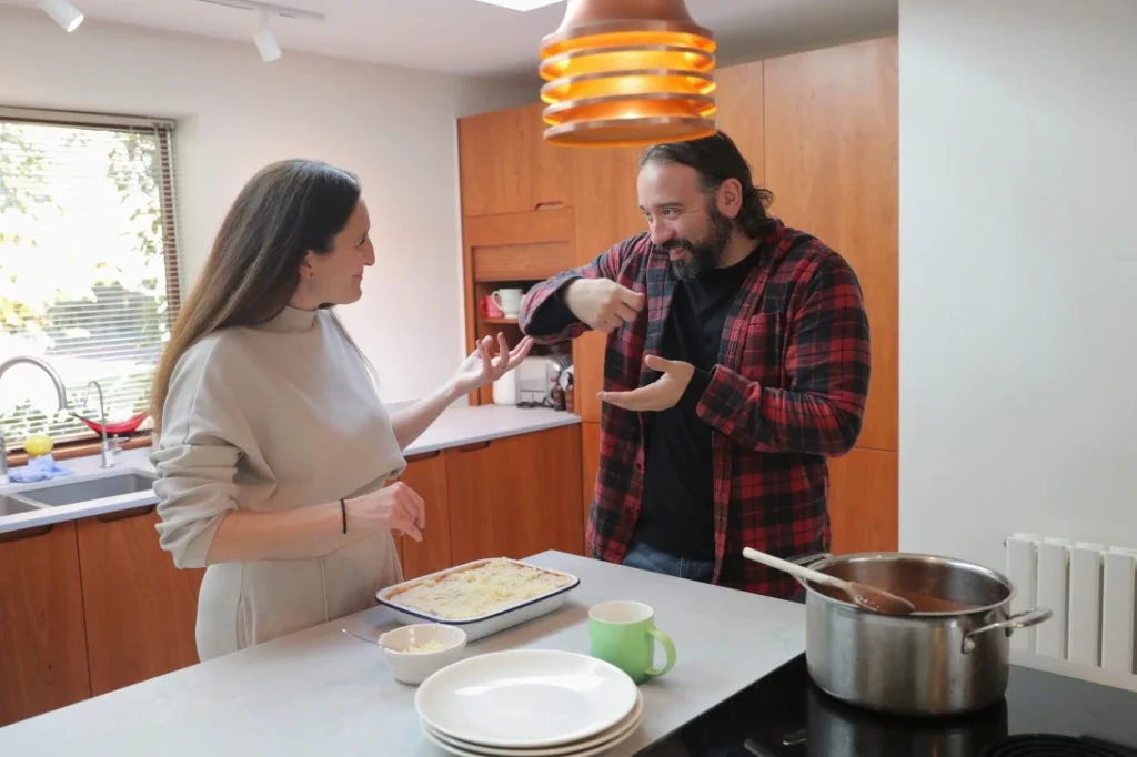 Two friends cooking in kitchen